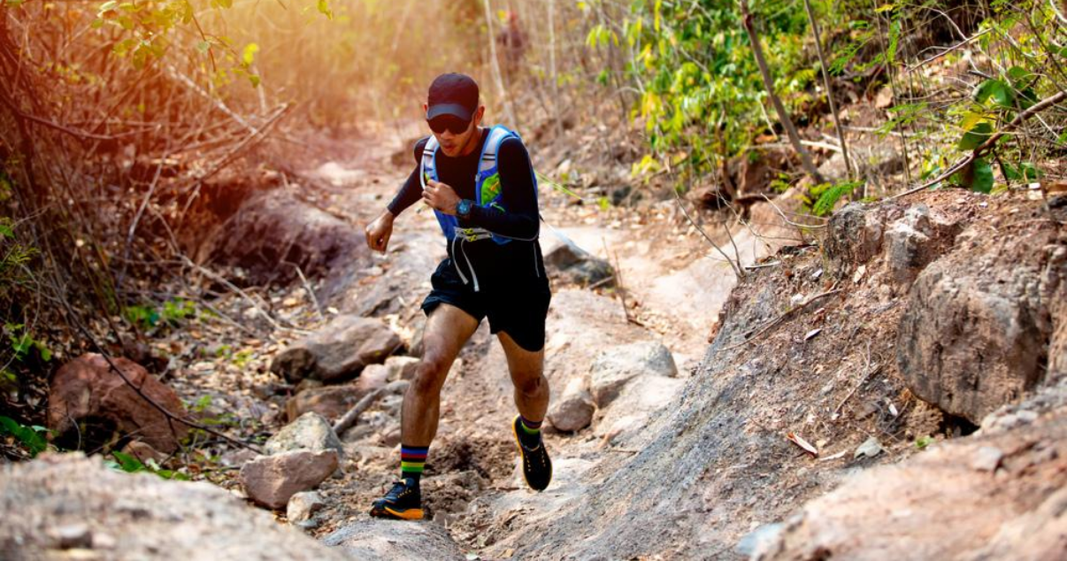 man hiking in the woods wondering how to best prevent athletes foot when exercising outdoors