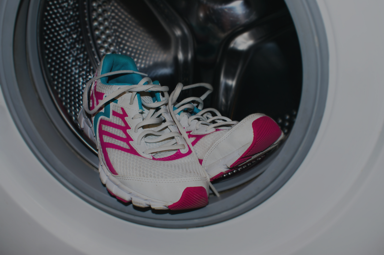 Shoes being washing in a washing machine to prevent athlete's foot