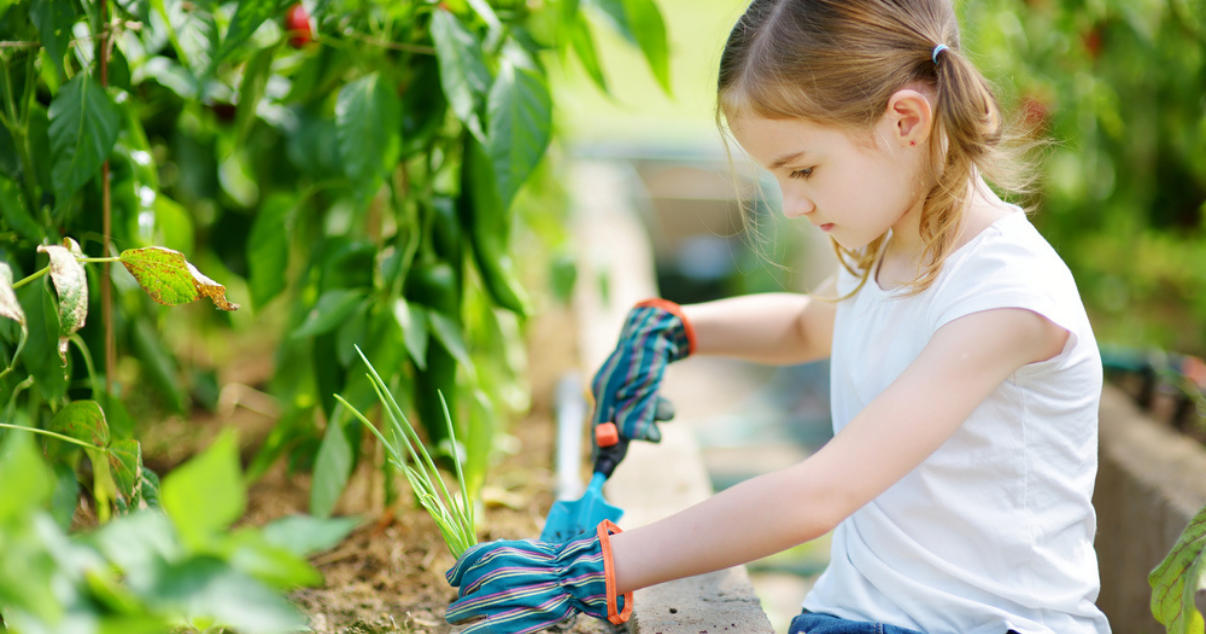 Girl gardening with her plastic shovel outdoors preventing a ringworm infection