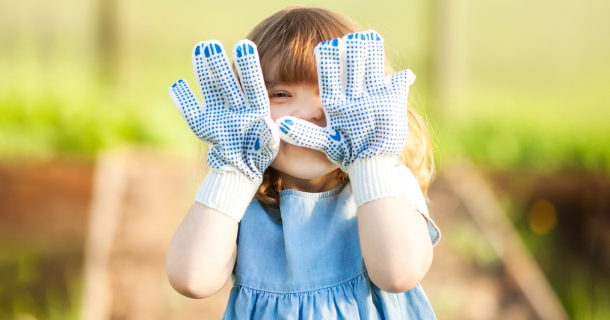 Girl using her gardening gloves outdoors preventing a ringworm infection