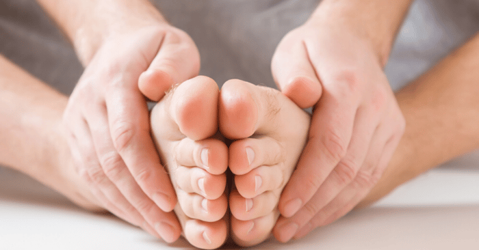 man doing yoga with healthy feet from preventing athletes foot